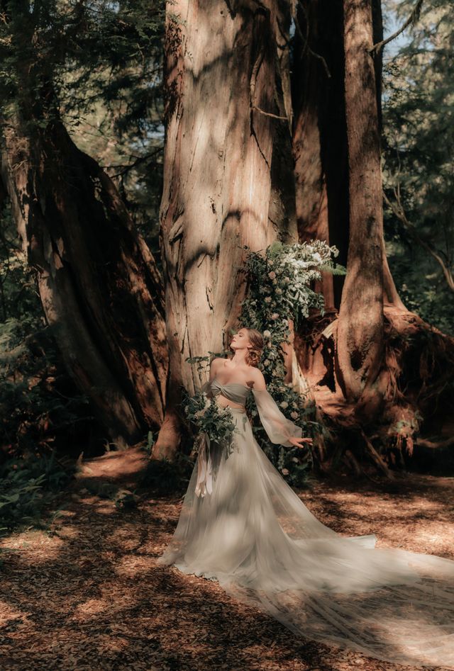 bride poses in front of large tree