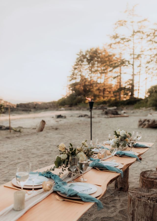 aqua colored folded napkins with gold cutlery place settings