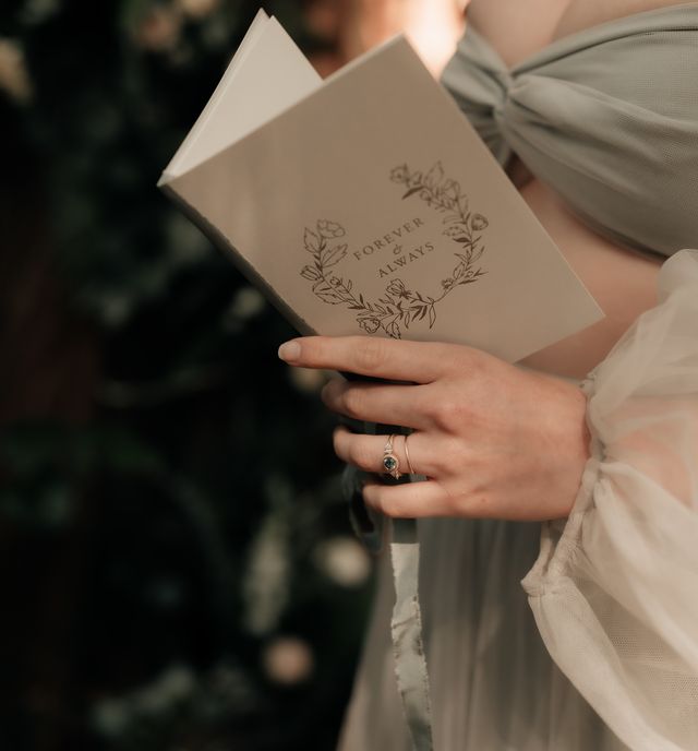 bride reads from vow book