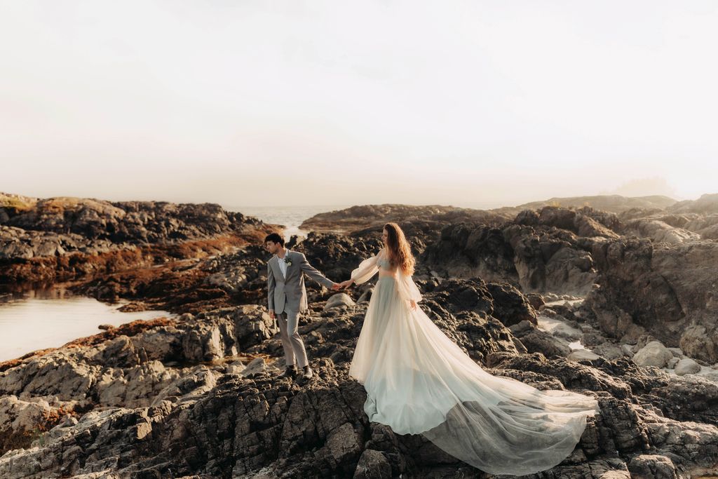 bride and groom walking on jagged rocks