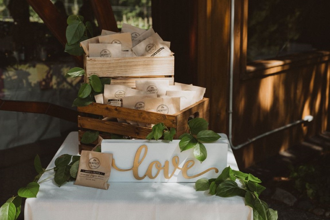 love sign on favour table crate filled with coffee packets