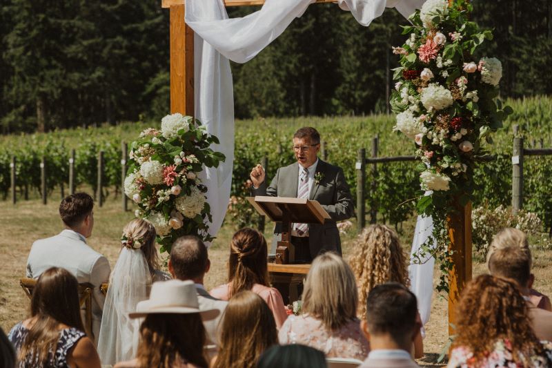 ceremony backdrop with large florals at Vancouver Island winery wedding