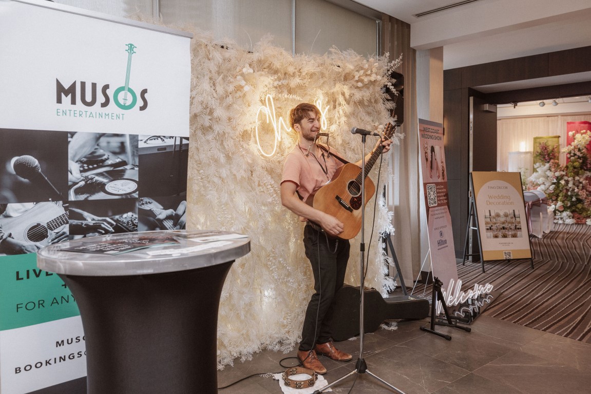 guitar playing in front of cream backdrop by Musos Entertainment at West Coast Wedding Show Vancouver