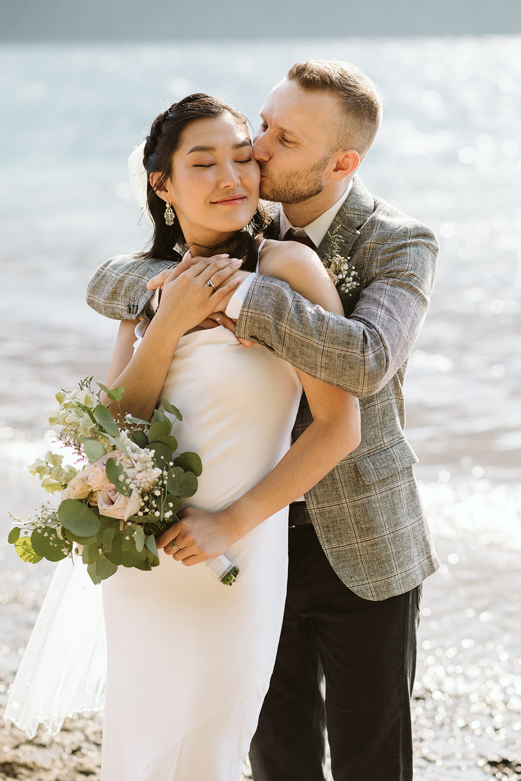 Bride and groom embrace after mountain wedding in BC