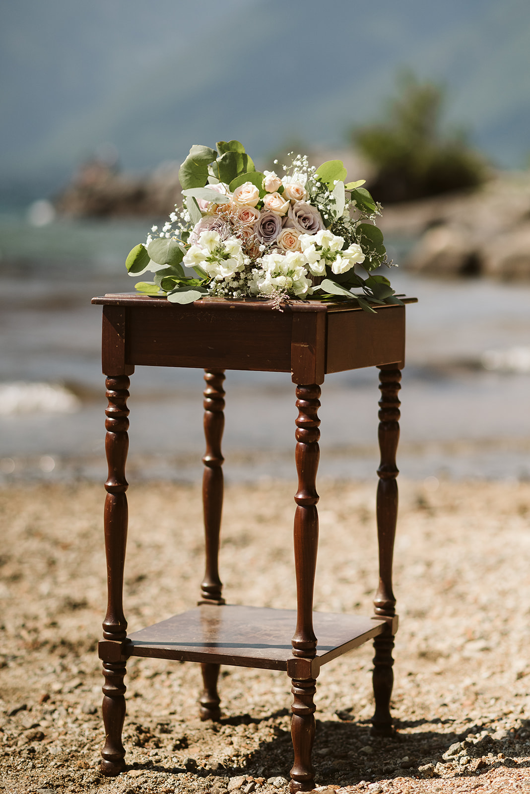 Flowers on antique stand at mountain lake ceremony in BC