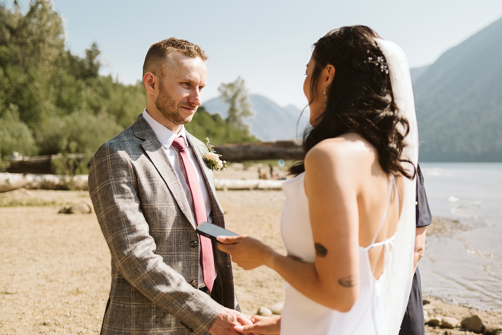 Ring exchange at mountain lake wedding ceremony