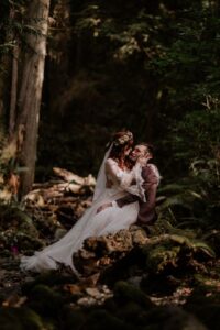 Newlyweds embrace in Vancouver Island rainforest