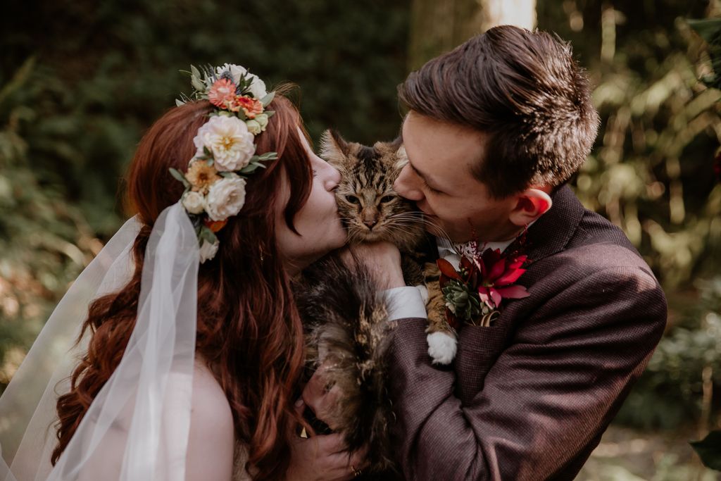 Bride and groom with cat ring bearer by LumiPhoto