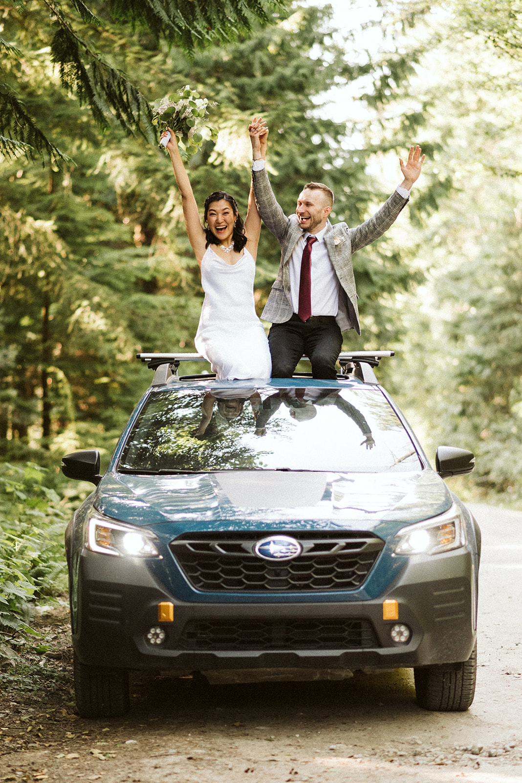 Newlyweds in off road vehicle celebrate wedding