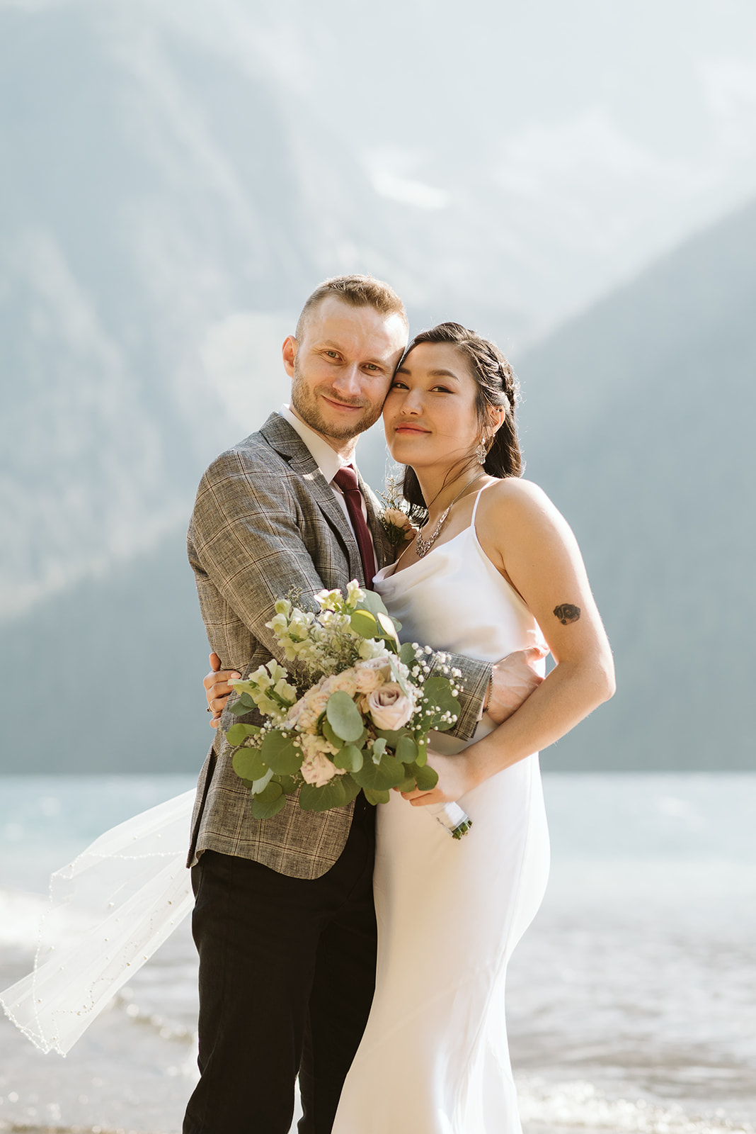 Newlyweds smile in front of BC Mountains