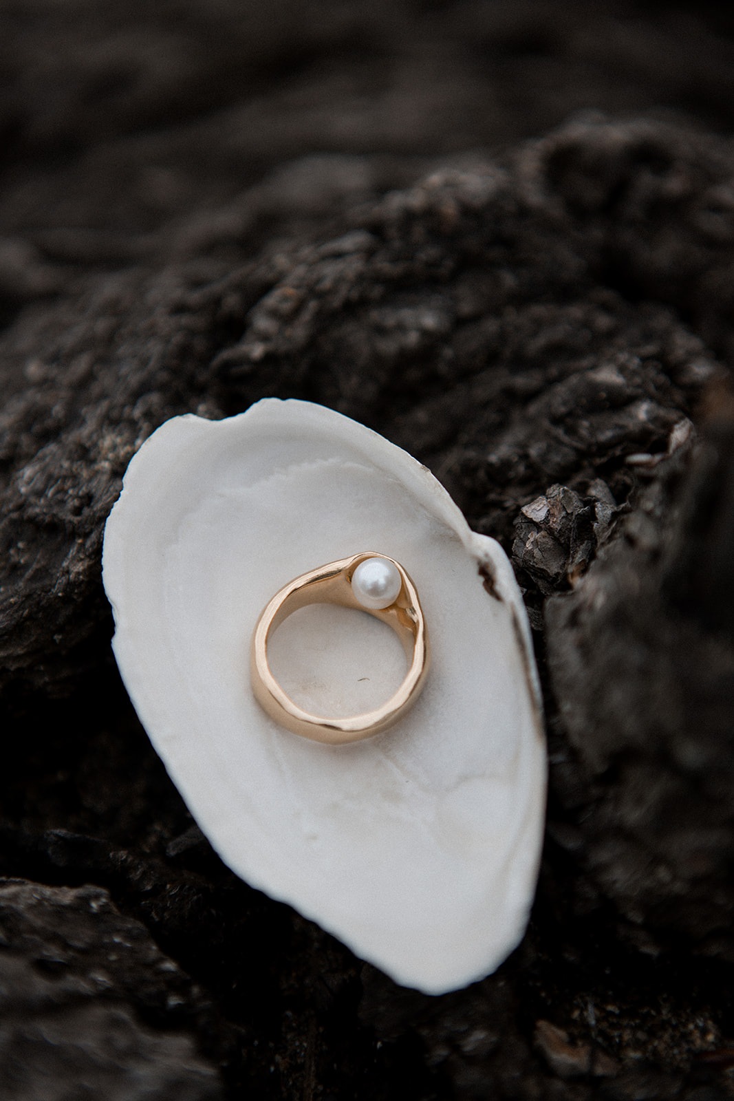 Kara Yoo gold and pearl wedding ring inside beach shell