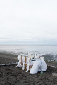 reception table with Chiavari chairs and white linens on vancouver beach