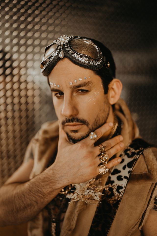 Glam rock groom in pilot goggles at airport elopement