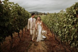 Newlyweds walk through Church and State Winery on Vancouver Island