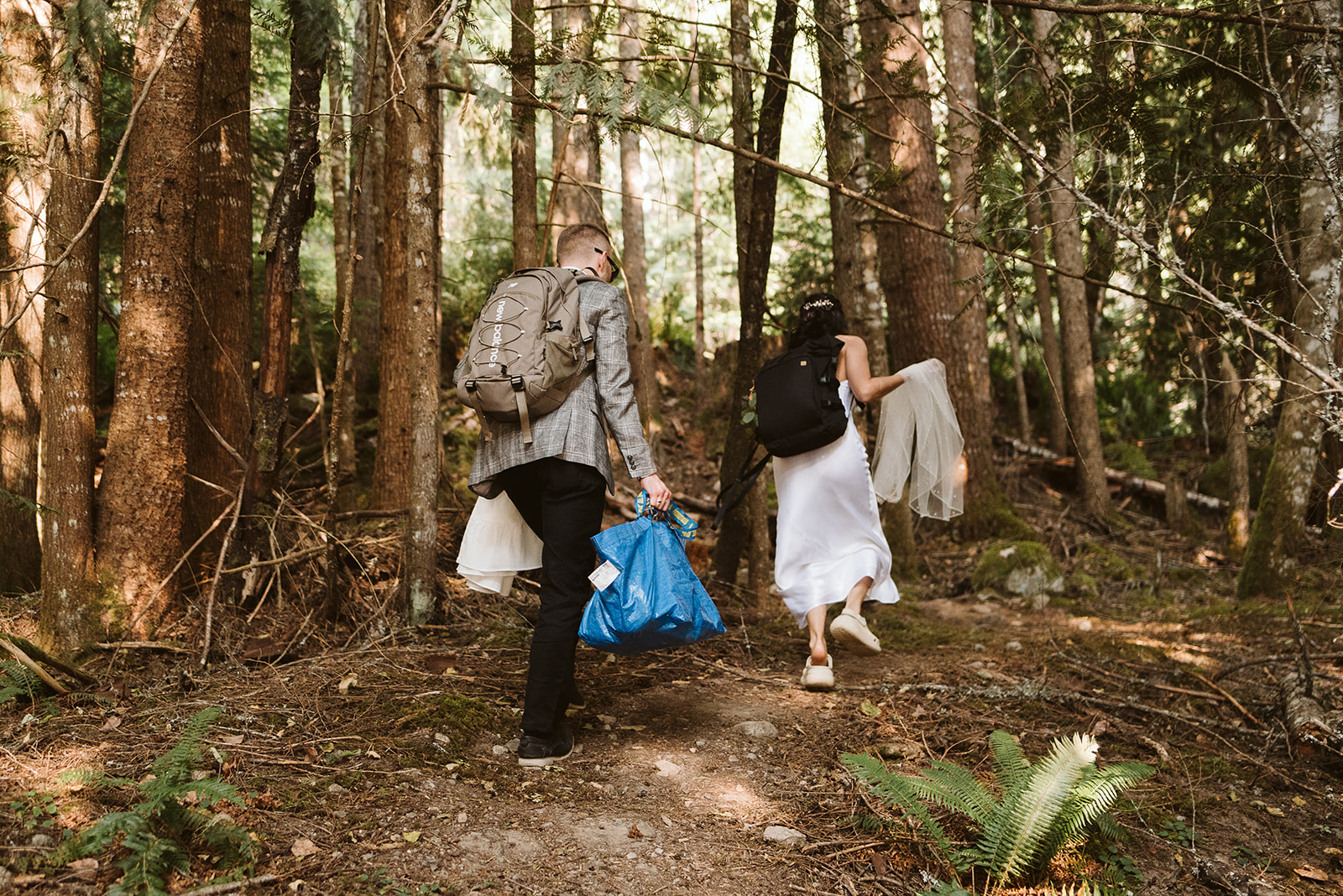 Bride and groom hiking from ceremony in BC