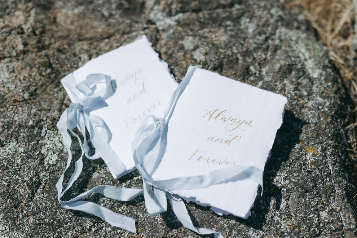 Vow books with blue ribbon by Robyn Paige Photography