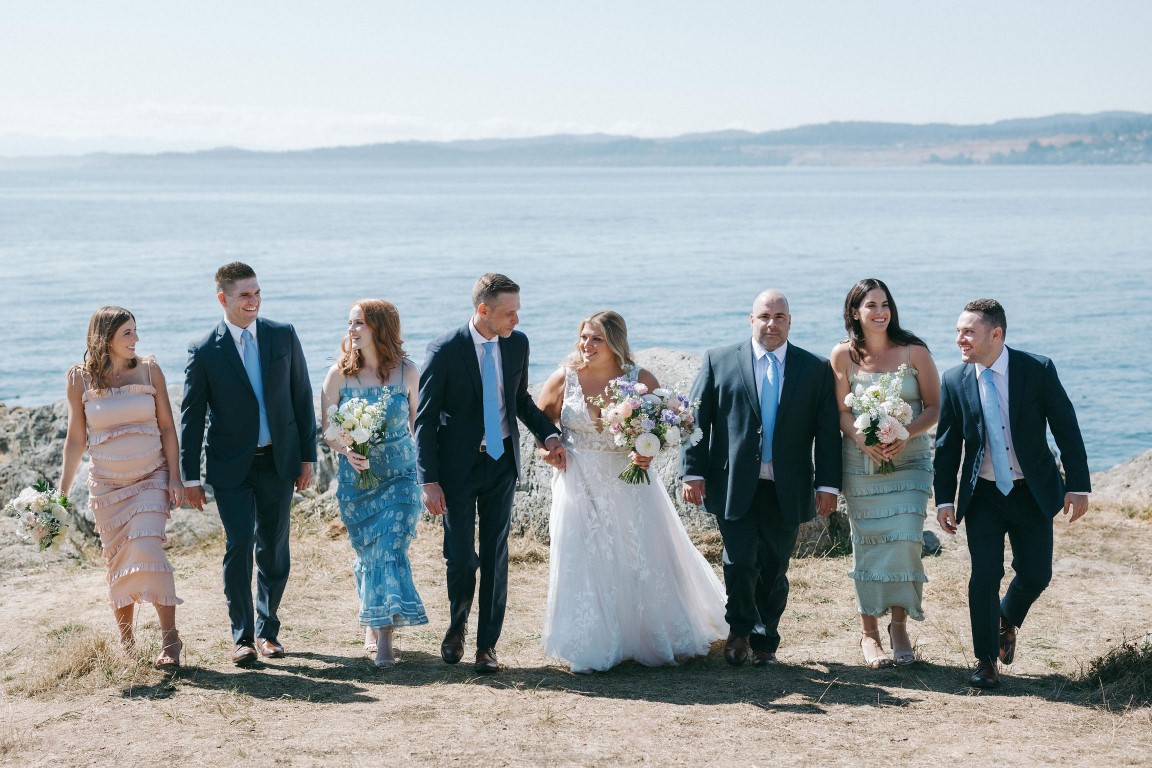 Wedding Party walk along rocks edge of Victoria Harbourfront