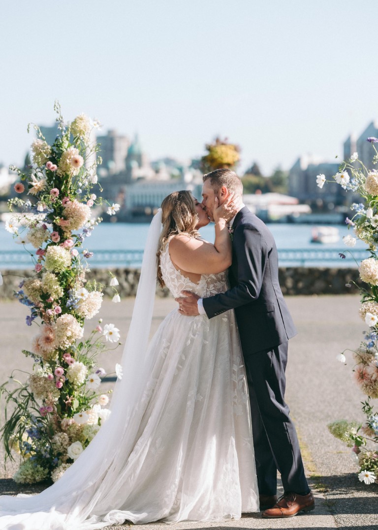 Bride and groom kiss at end of ceremony at Victoria Harbour Front