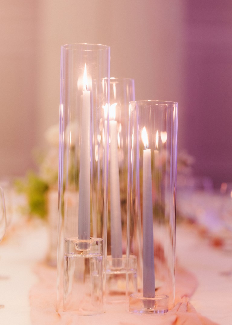 Grouping of tall glass candlesticks by Details Event Planning Victoria