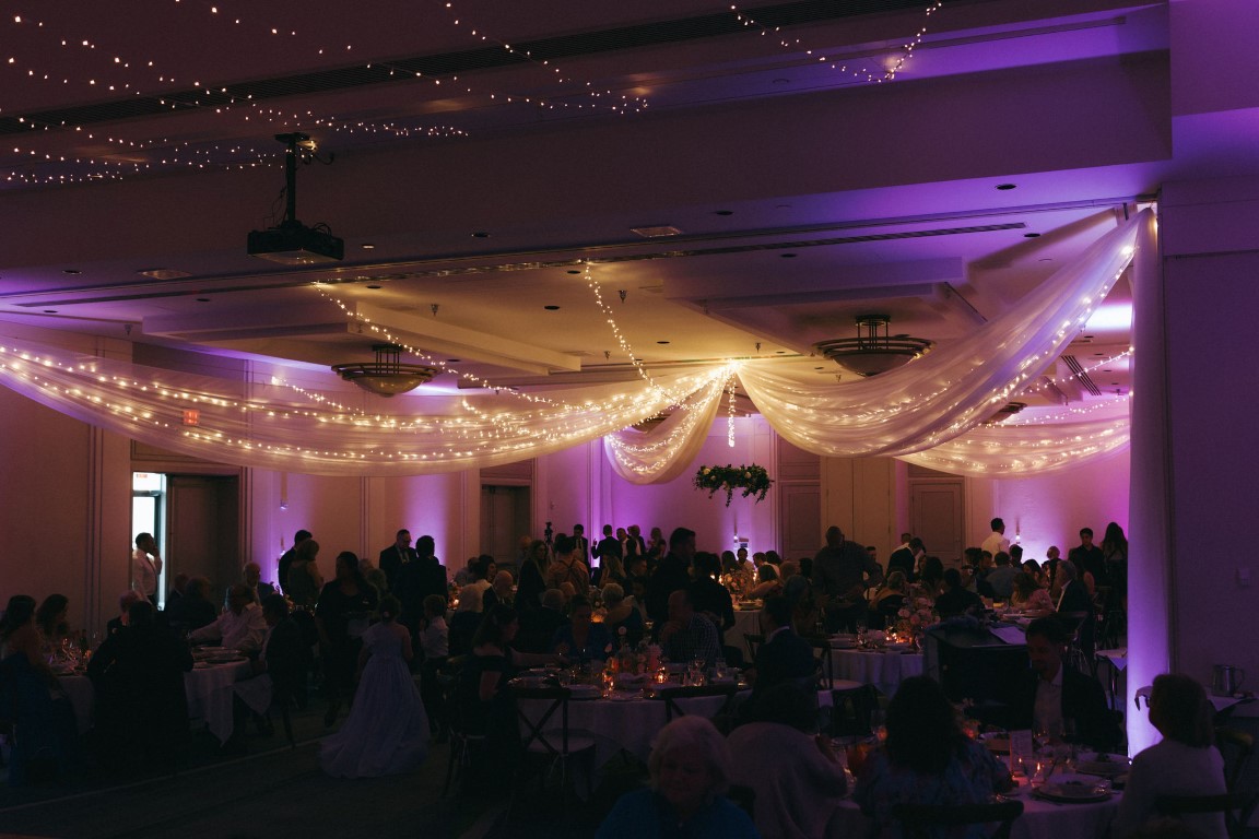 Guest dancing under reception lights at Delta Victoria