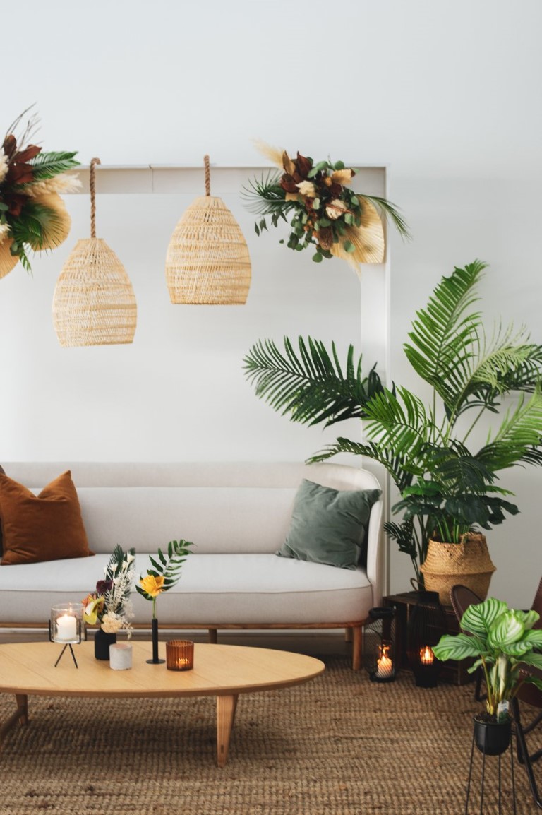 palm plant next to white couch with boho lights by Bespoke Vancouver