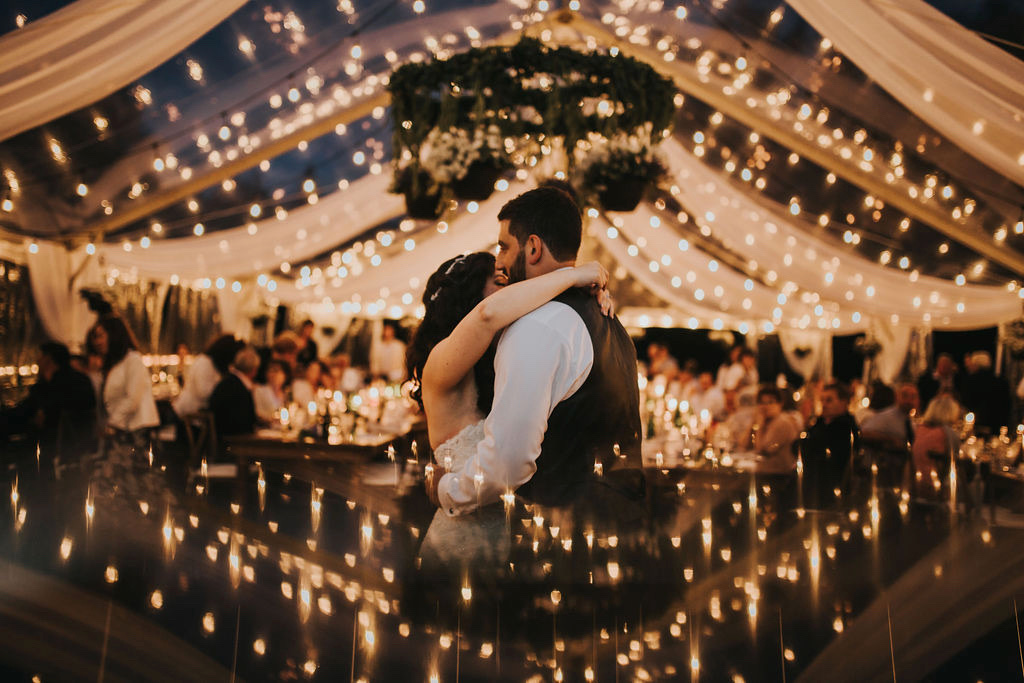 Newlyweds surrounded by lights by Rivkah Photography