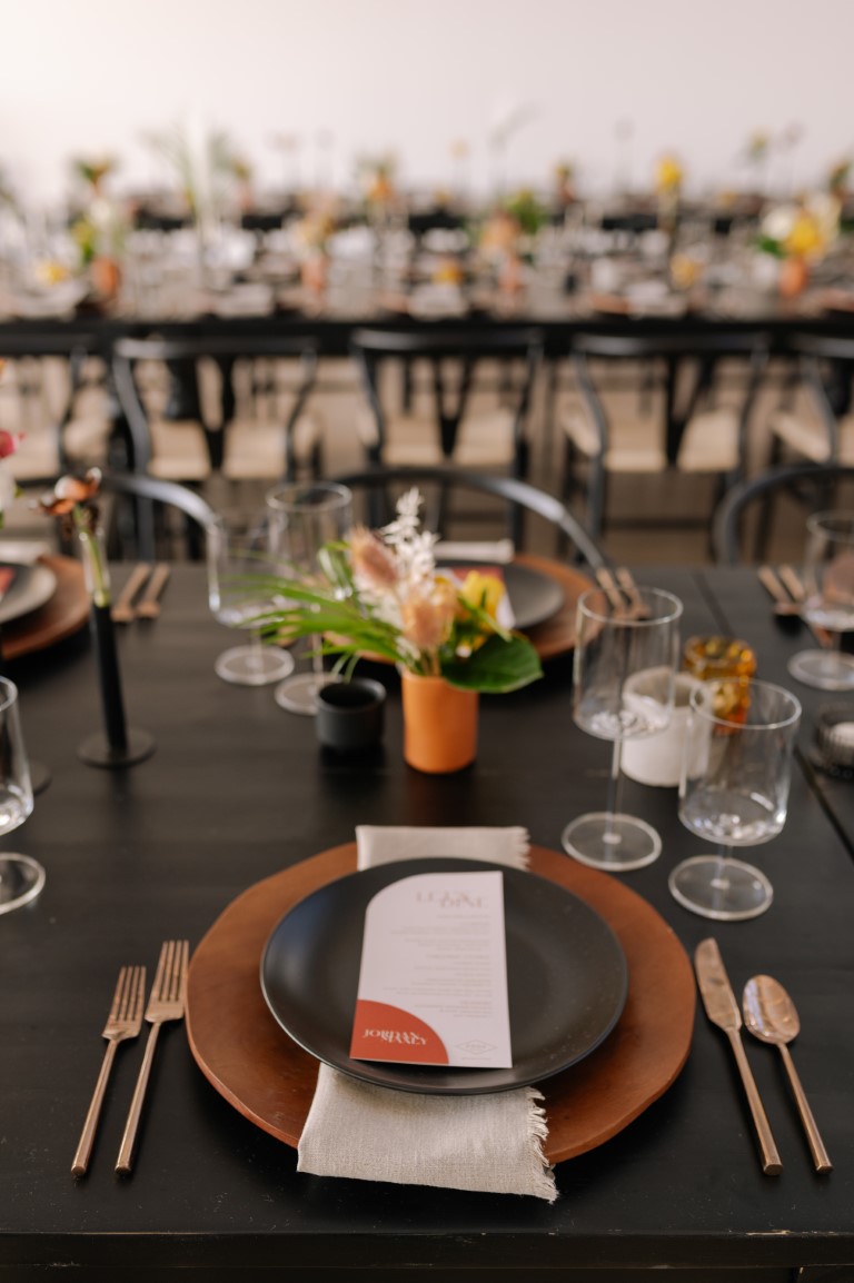 plated reception table with palm leaves and black plates by Bespoke Decor Vancouver