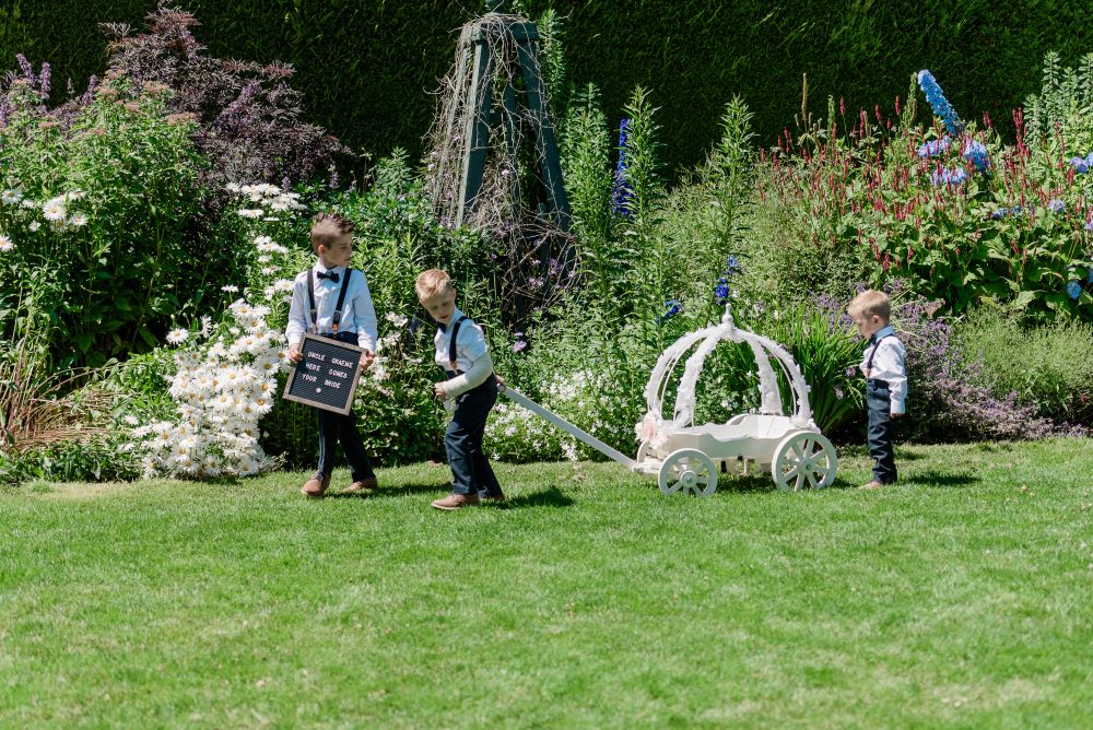 Ringbearers come across Hatley Castle garden