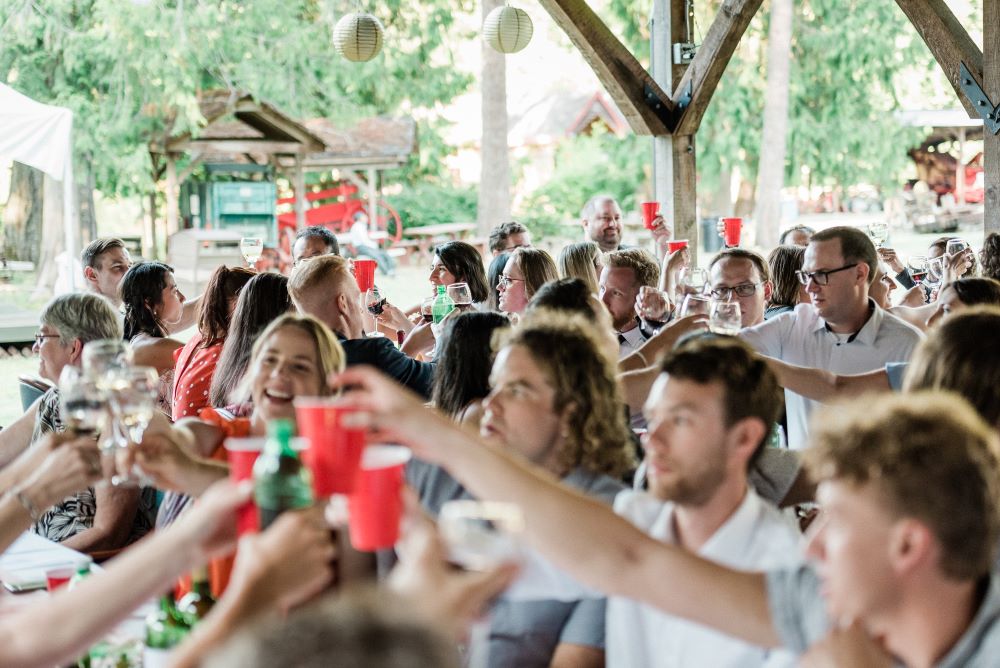 Wedding guests toast at Heritage Acres