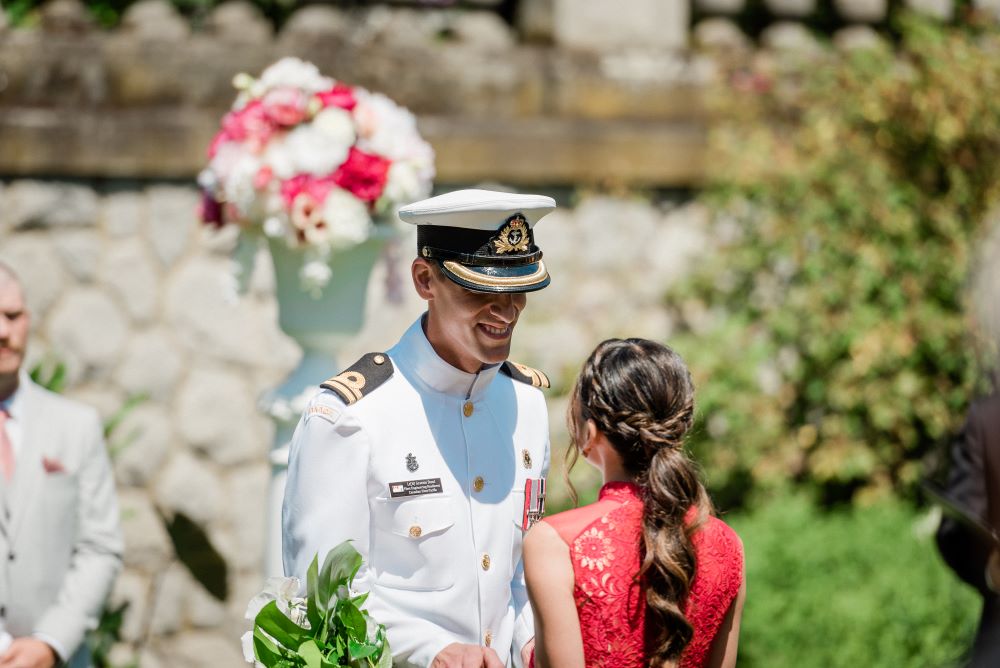 bride in red lace and groom in white army 