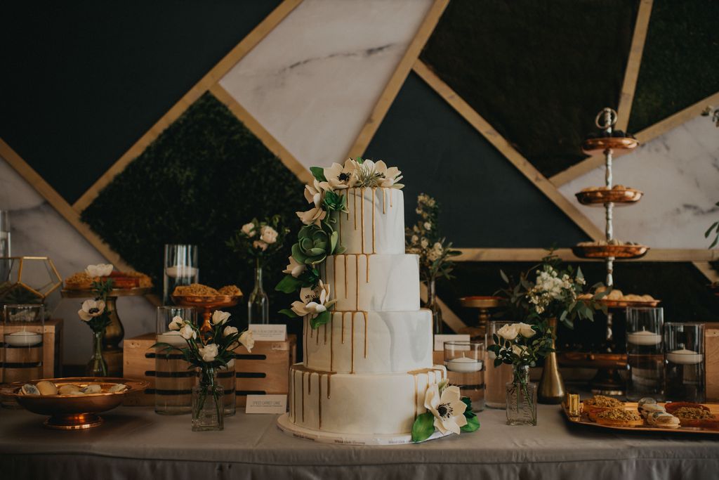 four tier white wedding cake with white anemones by Whisk Bakery Kelowna