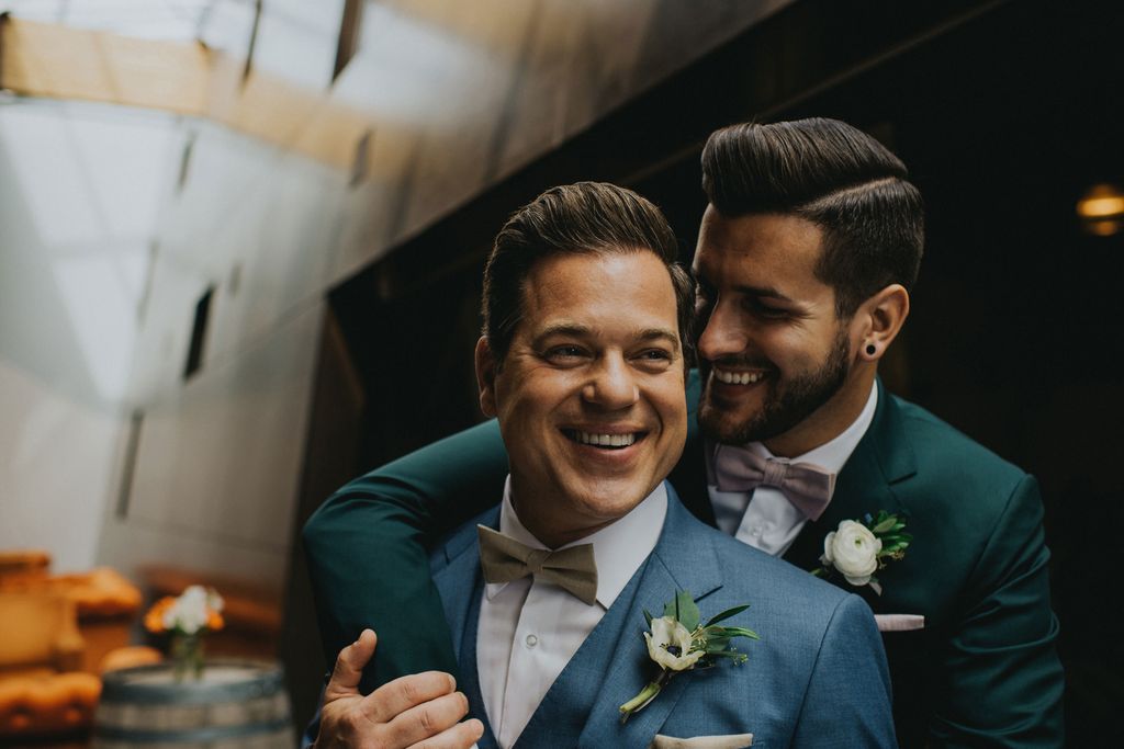 Happy smiles on LGBTQ grooms by Joelsview Photography