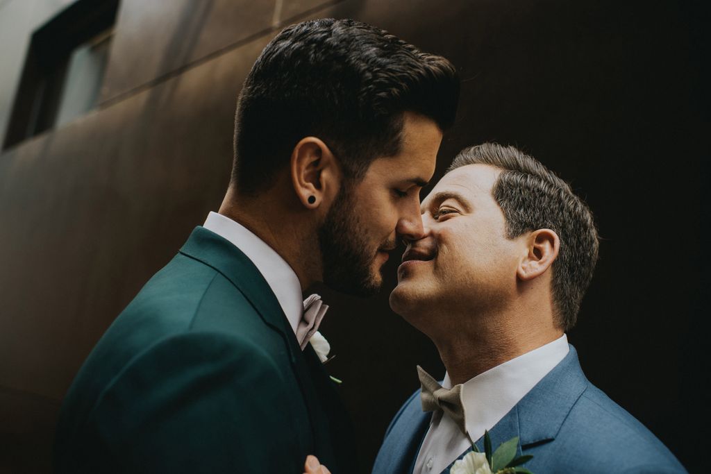 LGBTQ grooms kiss at blue wedding in Kelowna