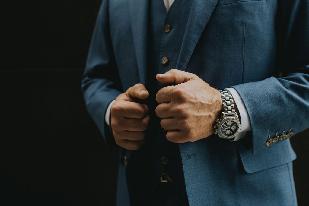 Groom with watch and blue suit by Joelsview Photo