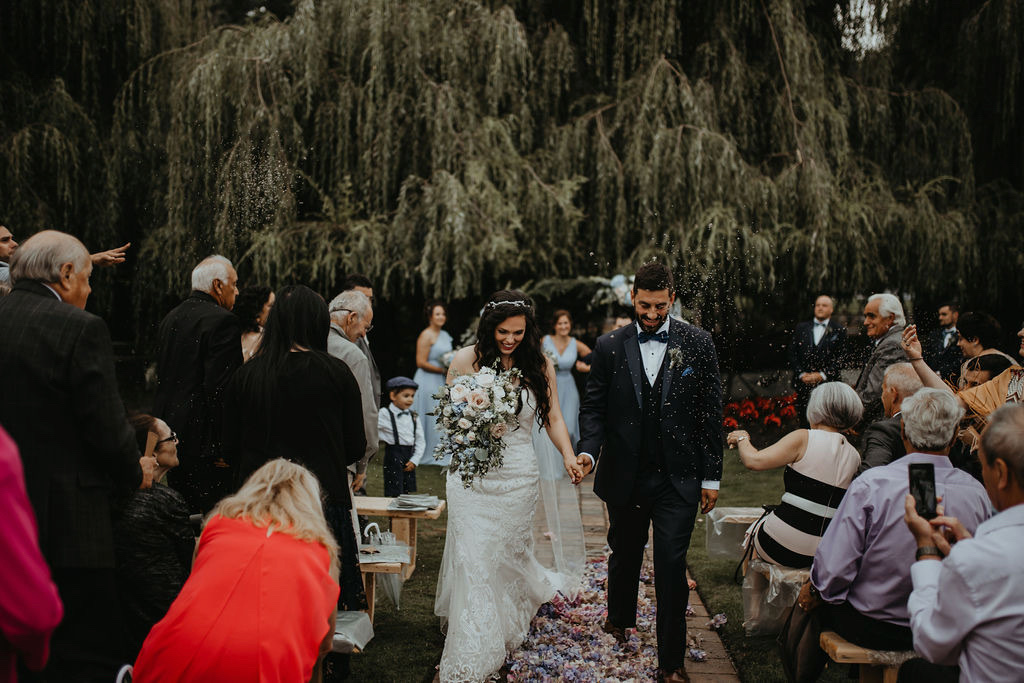 Bride and groom walk up aisle by Rivkah Photo