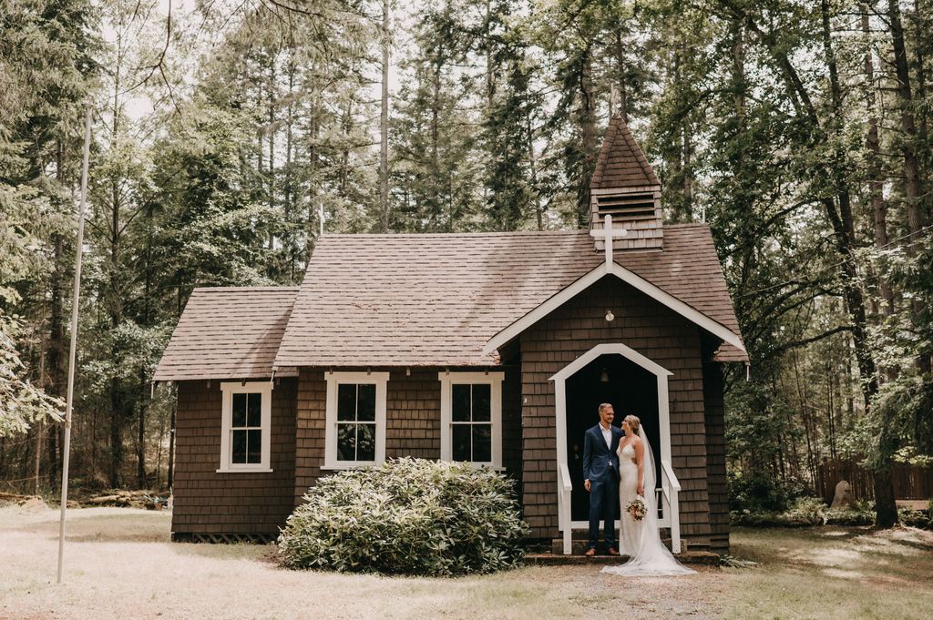 Newlyweds photo in front of cottage door on Pender Island