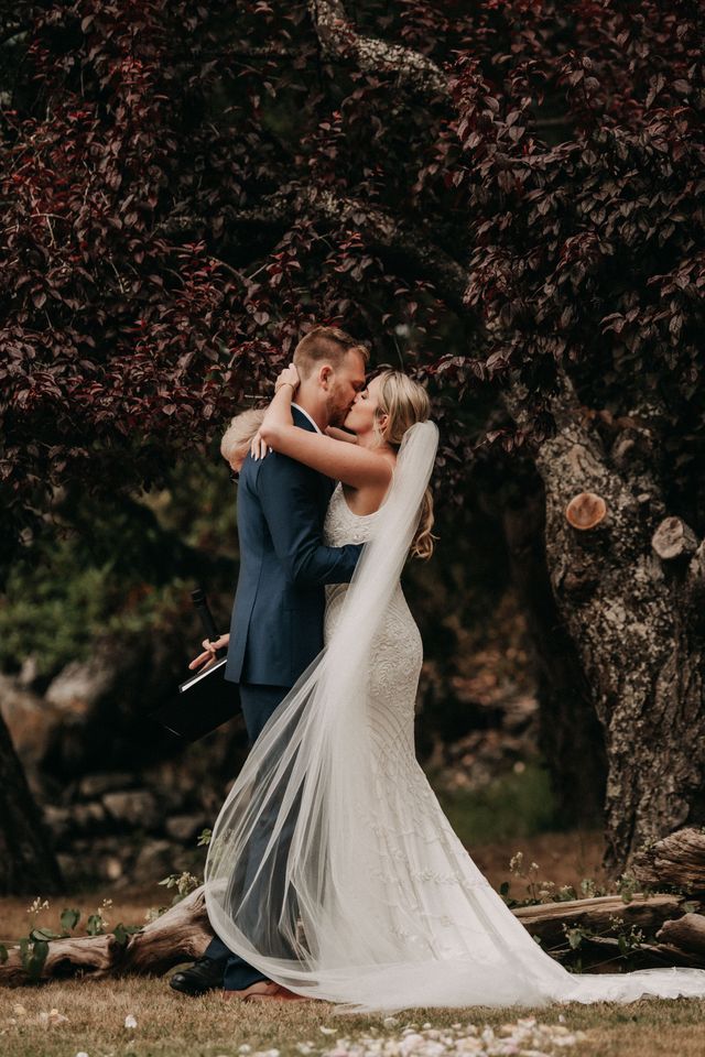 Newlyweds hold each other on Poet's Cove dock