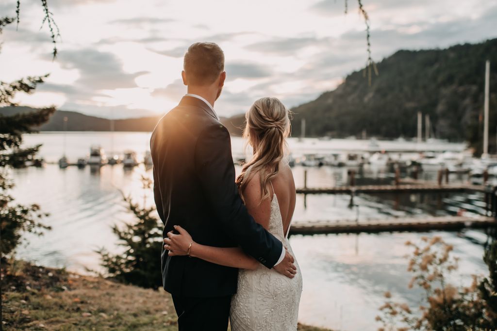 Newlyweds watch sunset from Poet's Cove Resort by Tulle and Tweed Photo