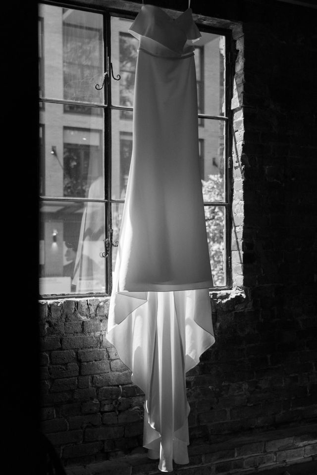 White wedding gown with light in window Made with Love Bridal