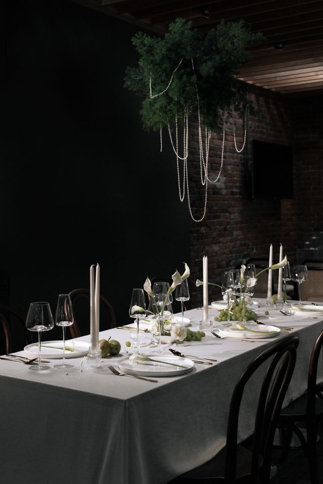 Black walls and white wedding table with cally lilies