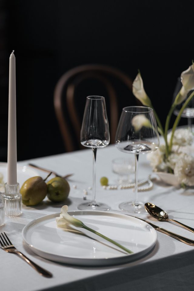 minimalist wedding table setting with white calla lily, pears, grapes and pearls