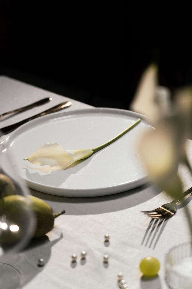 white calla lily, pears and pearls on plate at Vancouver wedding reception