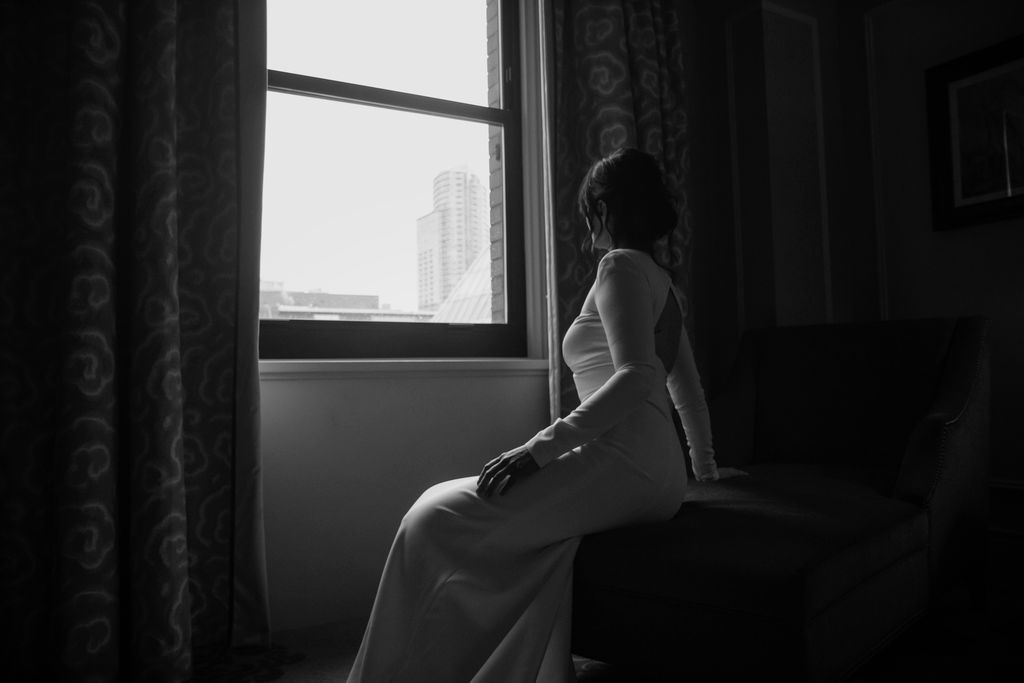 Bride looks out window