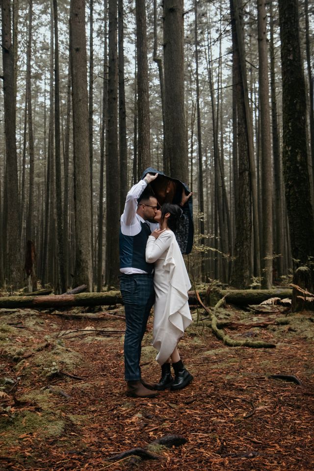 Newlyweds pose in rainforest by Kassy Davis