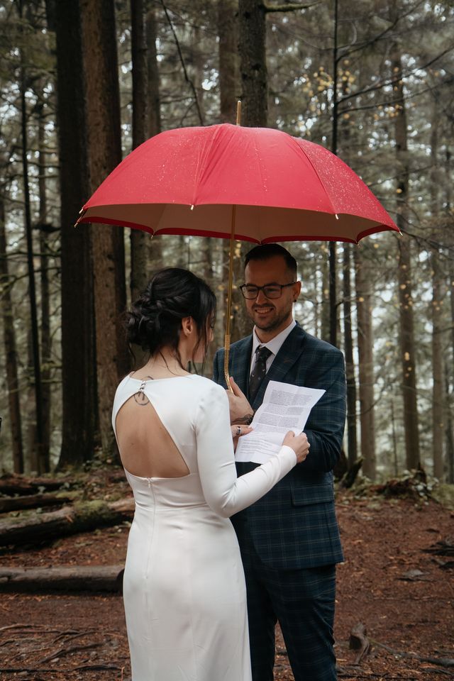 Rainy Reverie newlyweds under red umbrella in rainforest