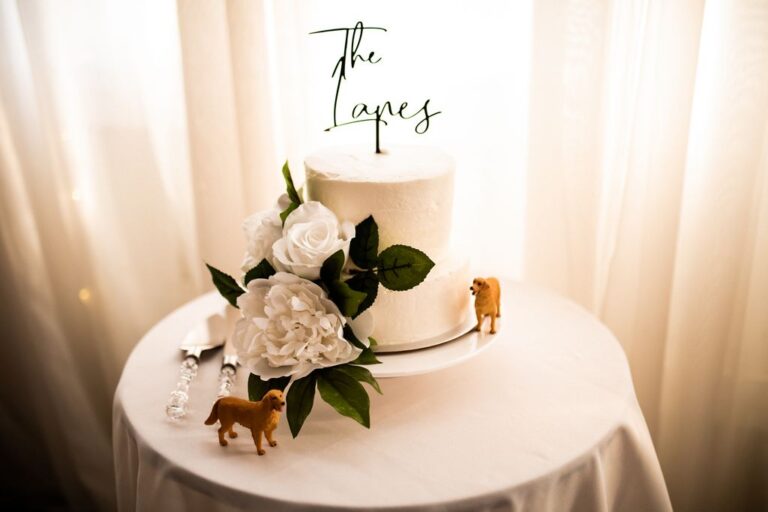 white two layer wedding cake with white flowers