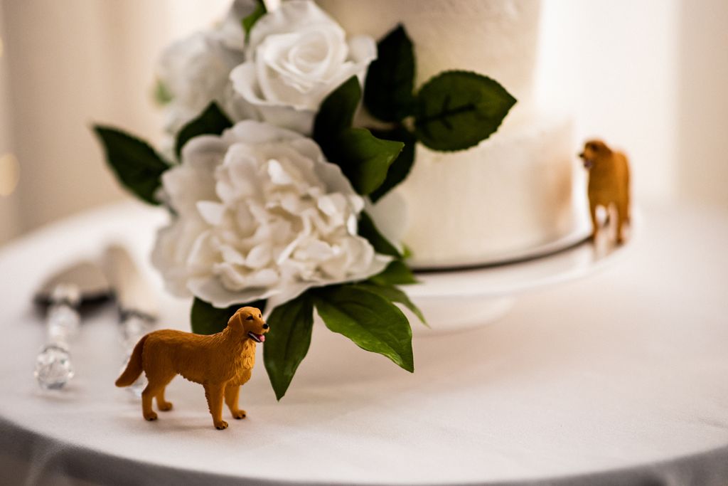 white flowers on white wedding cake at Golden Eagle Golf Club