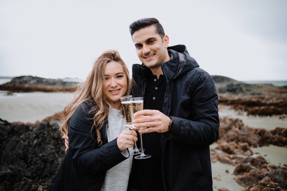 Engaged couple toast at Wickaninnish Inn