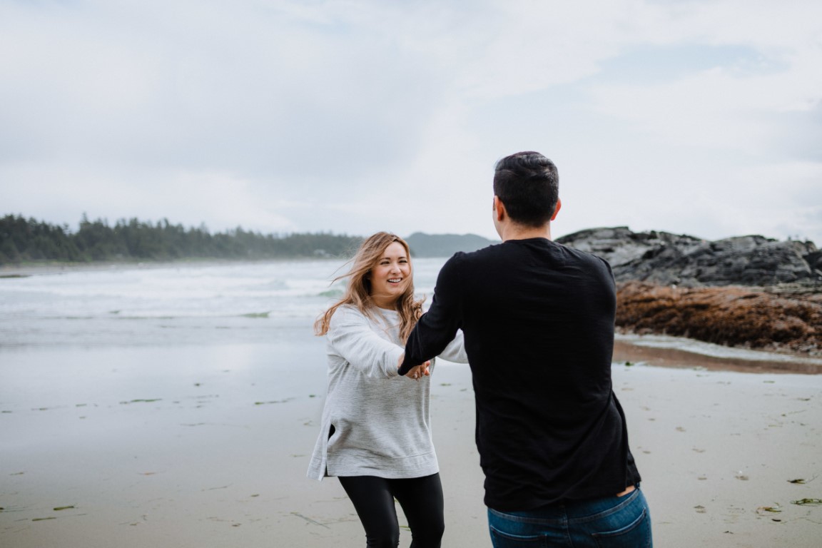 Engaged couple dance along Tofino beach