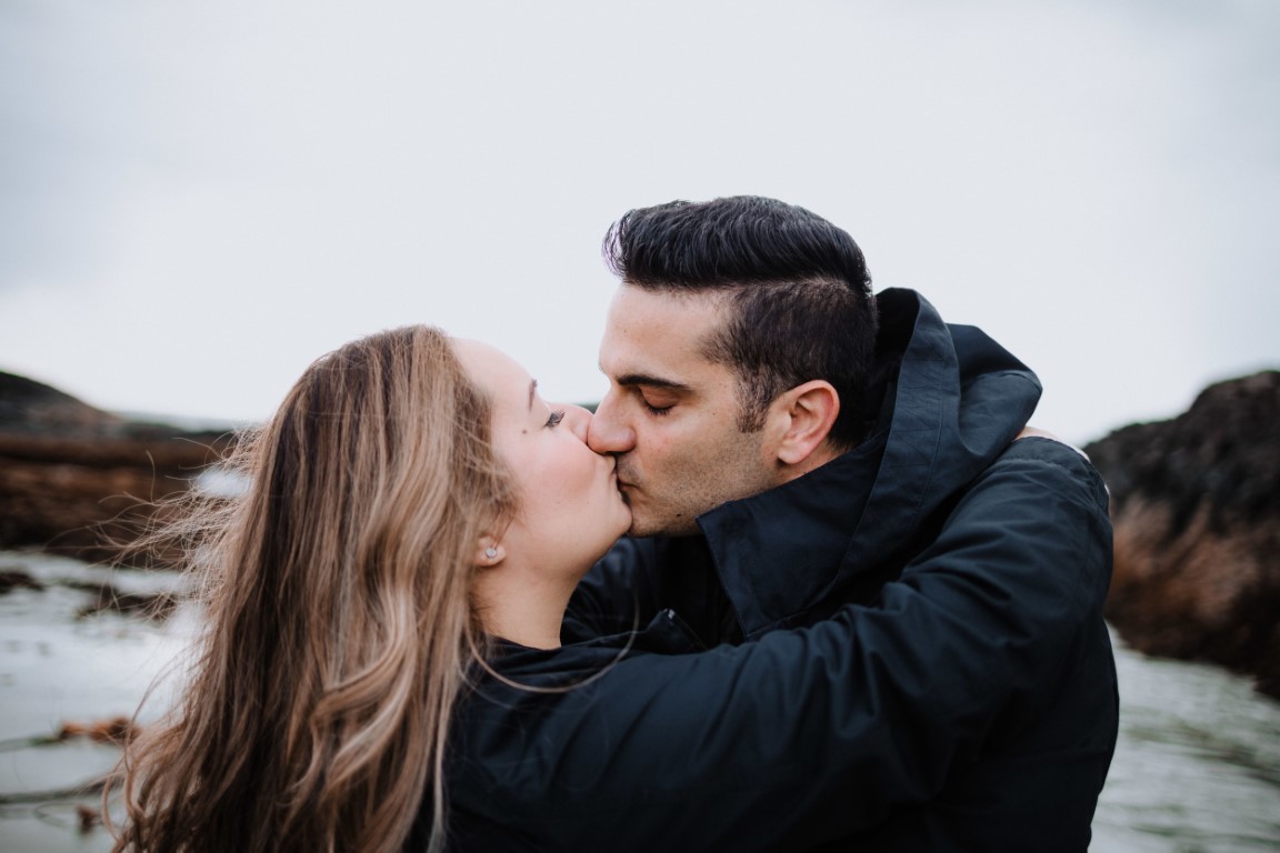 Engaged couple kiss 